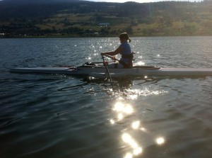 Joan in her rowing shell (boat) training on lake near Vernon, BC.